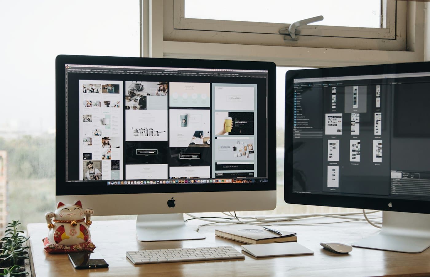 Web designer's desk with two monitors showing a design in progress