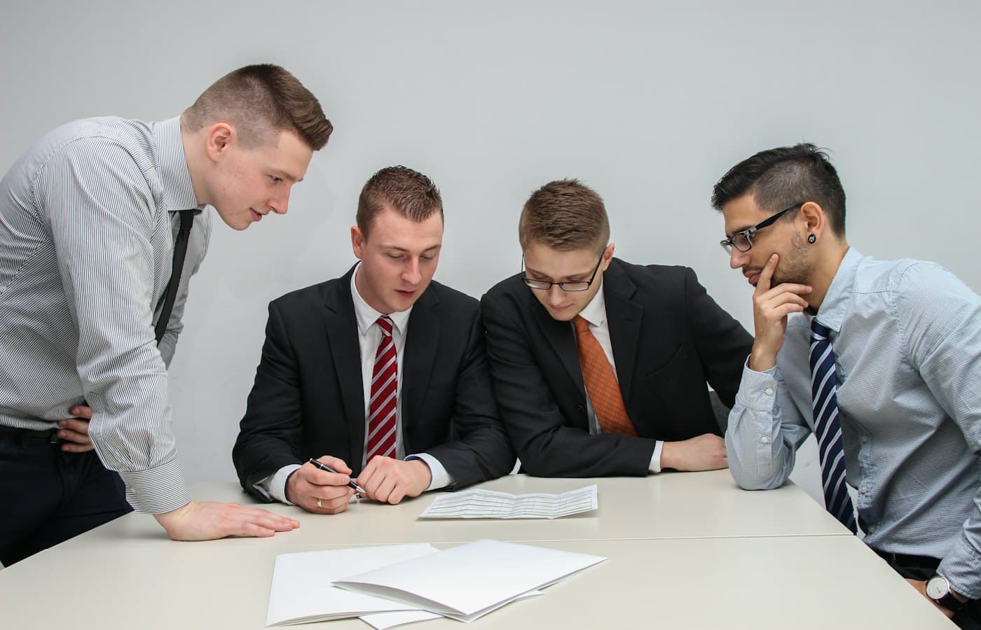 Financial advisors reviewing planning documents together at a meeting table